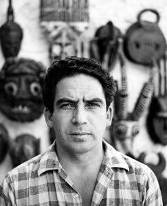 Oswaldo Vigas with his collection of African masks, Merida, 1966