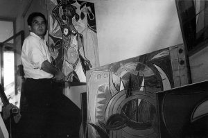 Oswaldo Vigas working on the assembly of his exhibition Las brujas, árbol genealógico: 1941-1952 in Galería 22, Caracas, 1966