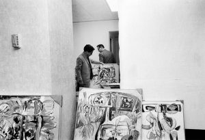 Oswaldo Vigas preparing the assembly of his exhibition Venezuelan witches at the Inter-American Development Bank, Washington D.C., 1967